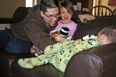 Daddy playing with Abbie and Caden on Christmas morning. 