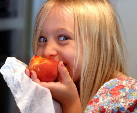 girl eating peach