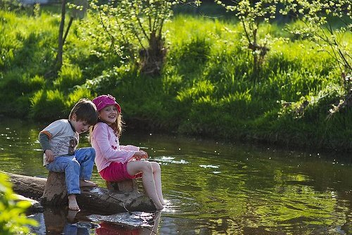 joyful kids by pond