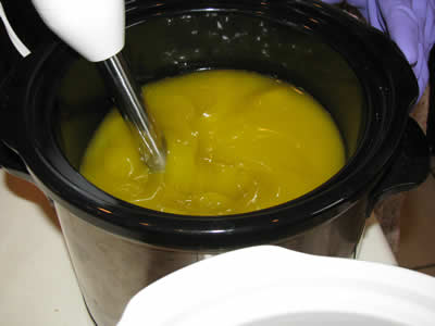 Carefully mixing the soap with the stick blender