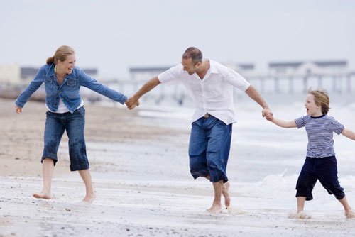 family having fun on beach