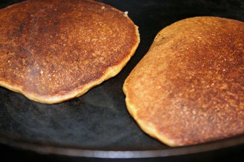 pumpkin pancakes cooking on cast iron