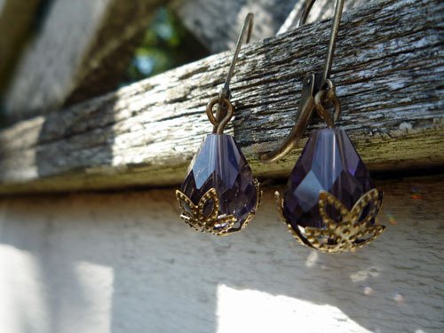 purple earrings on wood