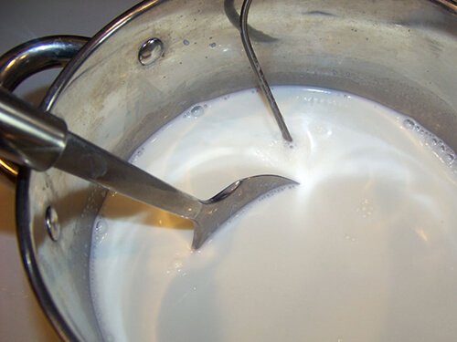 stirring homemade ricotta