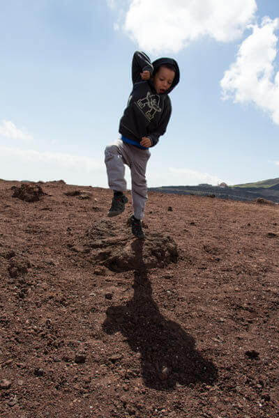 caden jumping at crater on mount etna