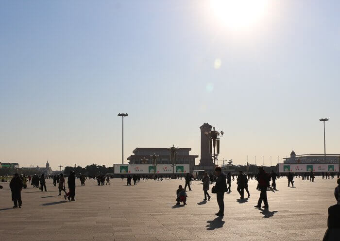 The sun shines dimmer through the haze in Beijing's Tian'anmen Square