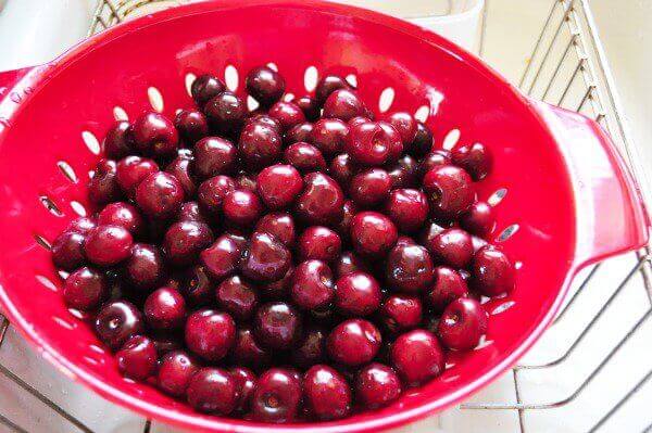 One of our favorite fruits to pick in the summer is cherries. We prefer sweet cherries but I know other's love tart cherries too, and I've figured out a way to easily pit cherries to get them ready to freeze. Here's how to do just that – plus 18 unique recipes to make those cherries shine!