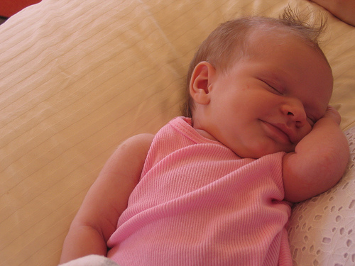 Sweet smiling newborn girl