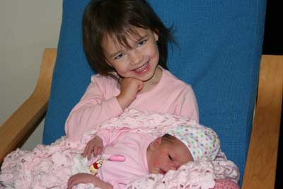 Abbie-holding-jo-in-blue-chair