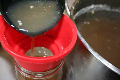 Pouring-thick-broth-into-jar